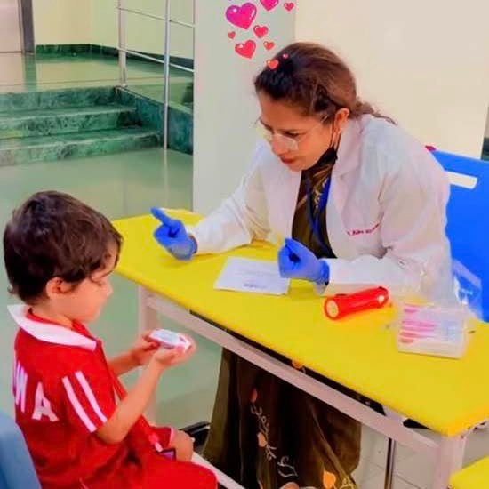 Dr. Alka examining a child during a dental checkup
